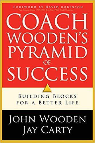 The book cover for Coach Wooden's Pyramid of Success by John Wooden and Jay Carty